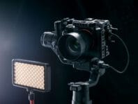 Professional digital camera on black background